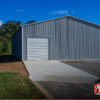Commercial metal garage building with one roll-up garage door on the side.