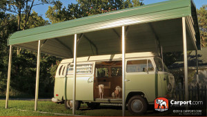 A stylish VW Bus parked beneath a green Elephant Structures carport with a regular roof. 