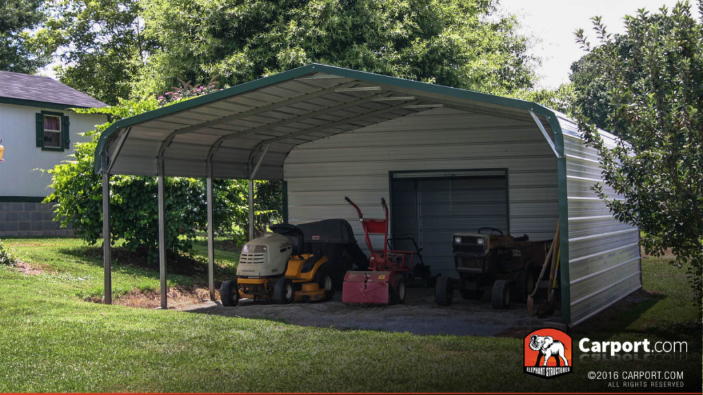 Utility shed carport with beige walls and green trim.